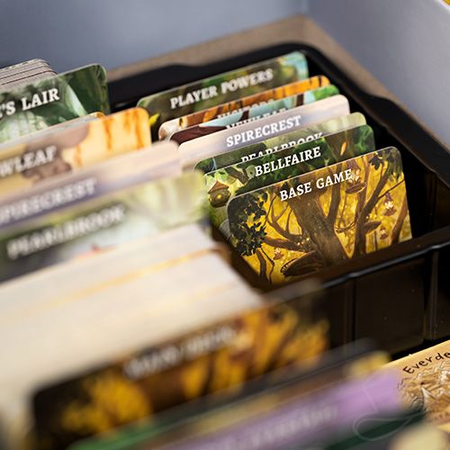 Detail image of the card tray for the Everdell Complete Collection showing the card dividers and cards from all the expansions. 